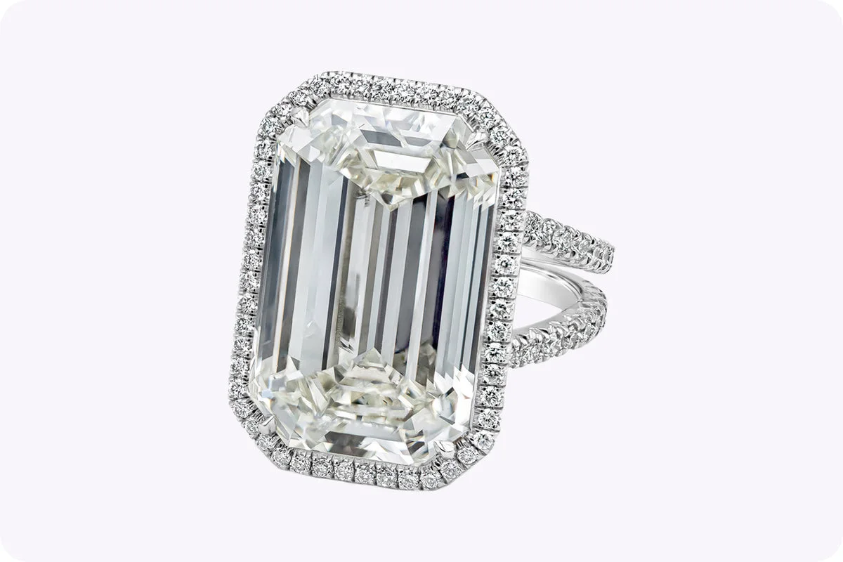 How a Ring Holds Its Stone: A Field Guide to Settings 4. Emerald cut diamond ring with brilliant halo in platinum, angled closeup