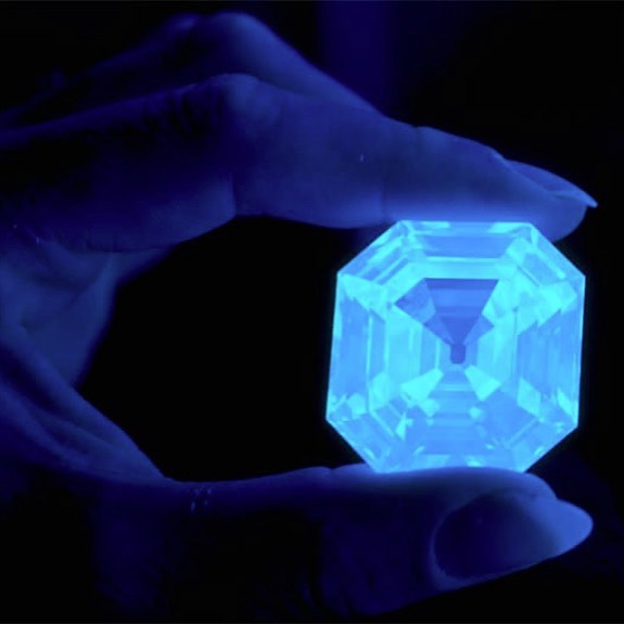 Large Asscher cut diamond glowing blue under UV ultraviolet light – GIA certified exceptional stone
