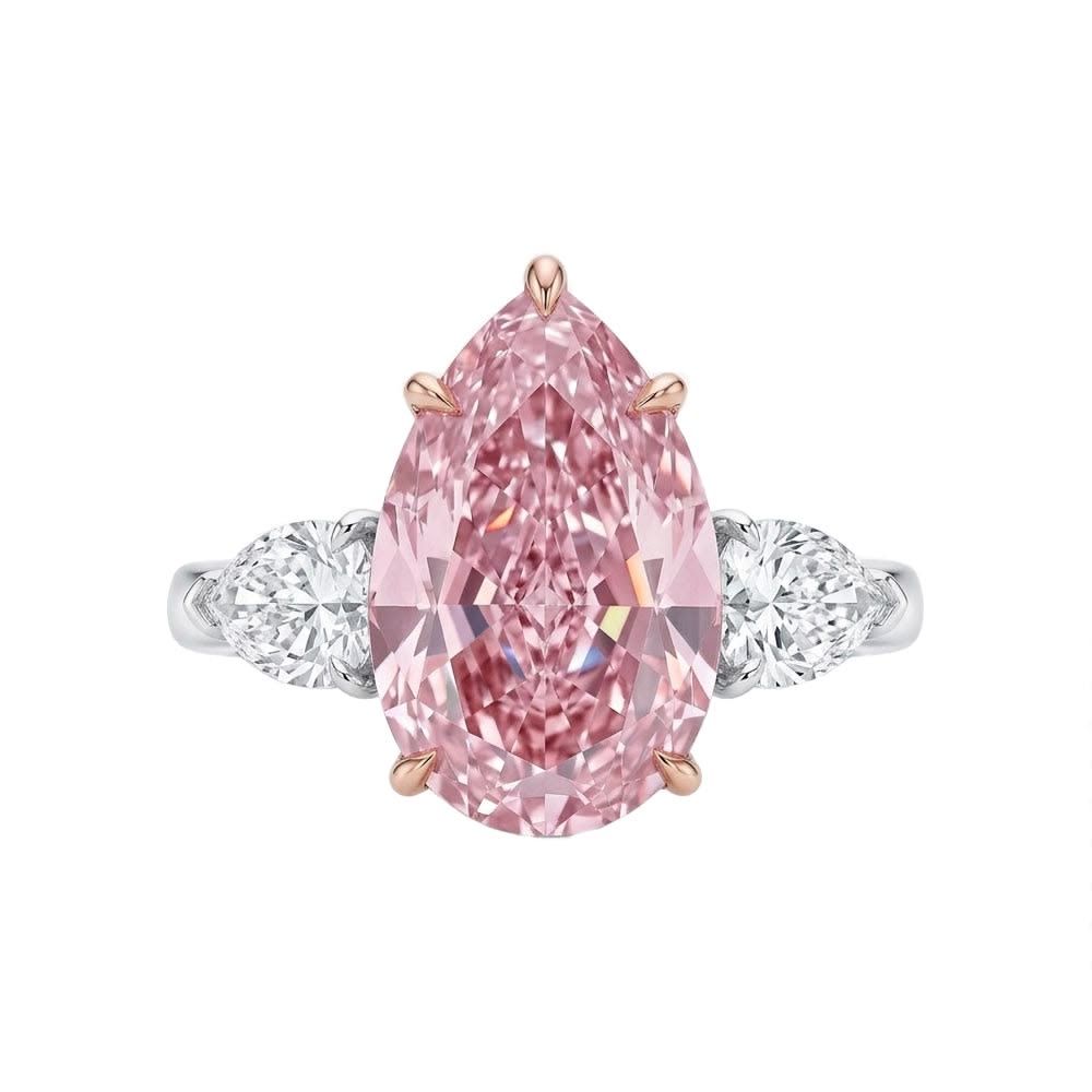 5.80 carat Fancy Pink Pear Diamond in three-stone ring with white diamond side stones
