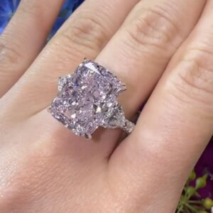 7.13 carat Light Pink Radiant Diamond set in ring, worn on hand