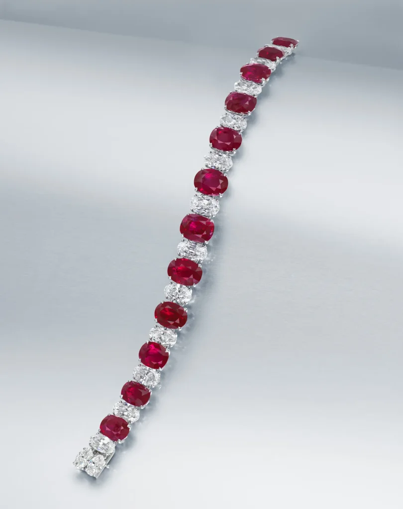 An Exceptional Ruby and Diamond Bracelet Twelve Oval and Cushion-shaped Rubies of 3.73 to 2.11 Carats, Oval-shaped Diamo