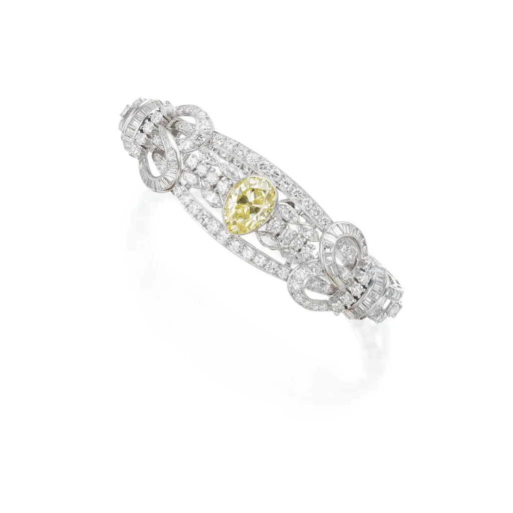 Fancy Light Yellow and Diamond Bracelet of Stylized Scroll Design, Centering an Pear-shaped Fancy Light Yellow Diamond with