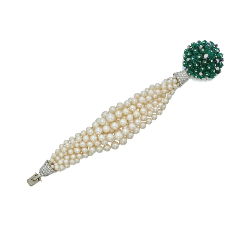 A Historically Important Cultured Pearl, Emerald, Diamond and Enamel Bracelet
