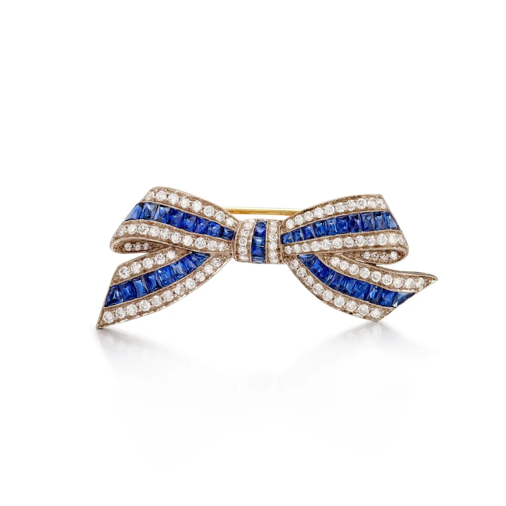 Sapphire and Diamond Brooch | Designed As a Tied Bow, Set with Calibré-cut Sapphires and Brilliant-cut Diamonds, Mounte