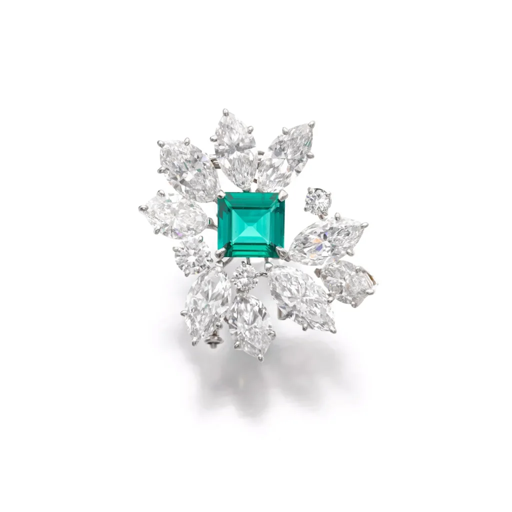 Superb Emerald and Diamond Brooch Set with a Step-cut Emerald Weighing 3.53 Carats, Surrounded by Marquise-shaped and Br