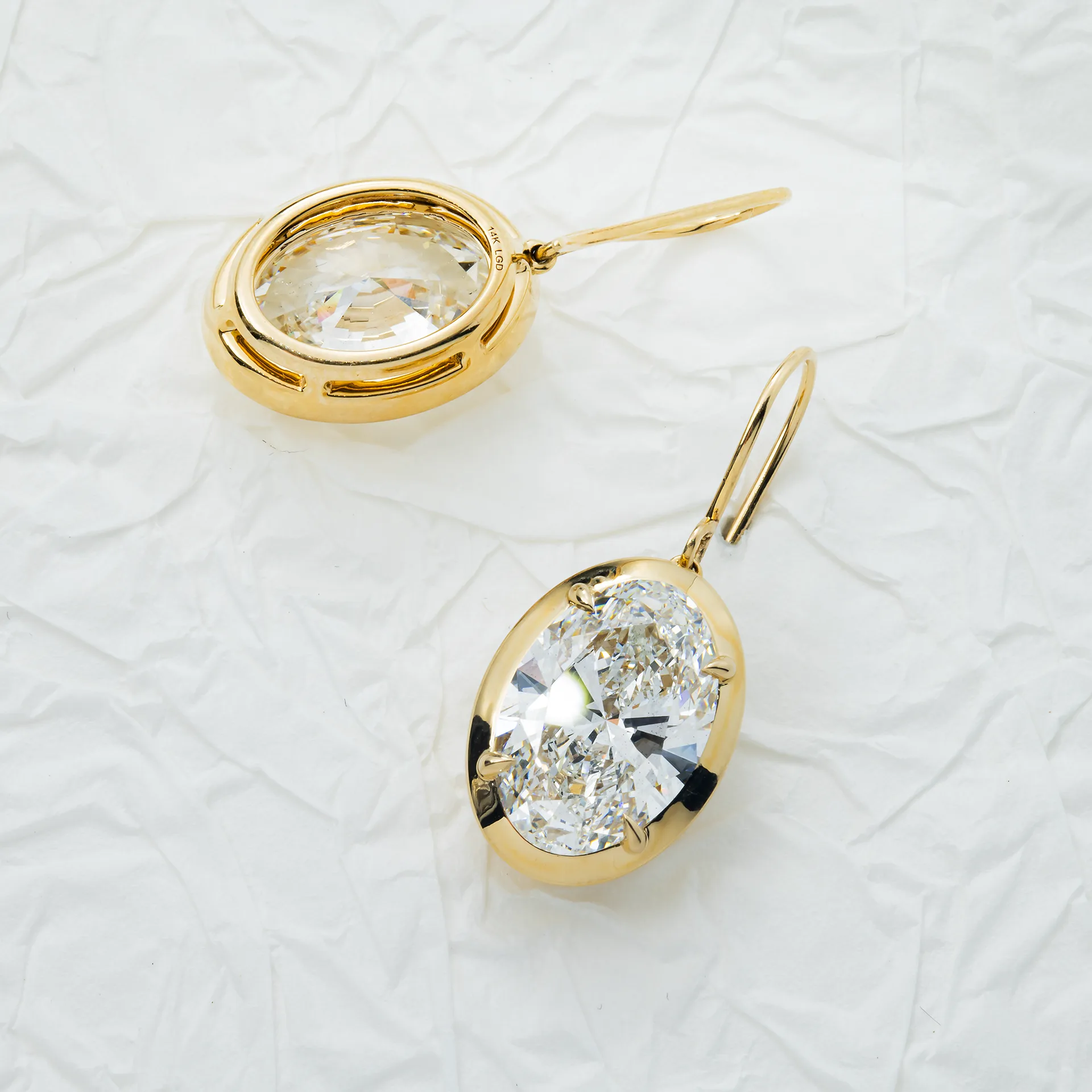Zendaya Closes Schiaparelli, and Gold Becomes Couture 2. Yellow gold bezel set oval diamond drop earrings, closeup of the gold rims