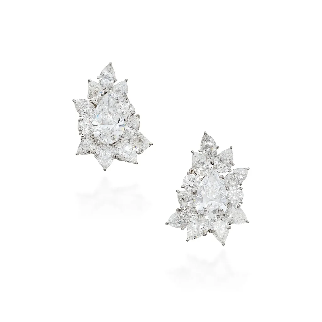 Pair of Diamond Earclips| of Cluster Design, Each Centering a Pear-shaped Diamond Weighing 5.01 Carats, Accented by Roun