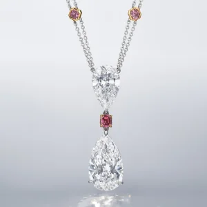 A SPECTACULAR DIAMOND AND COLOURED DIAMOND PENDENT NECKLACE Pear brilliant-cut diamond of 20.70 and 10.02 carats, fancy