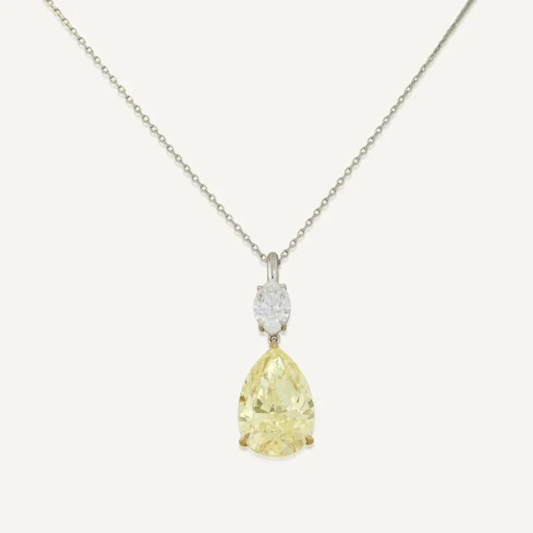 Fancy Yellow pear modified brilliant diamond of 5.12 carats, marquise-cut diamond, fine link chain necklace