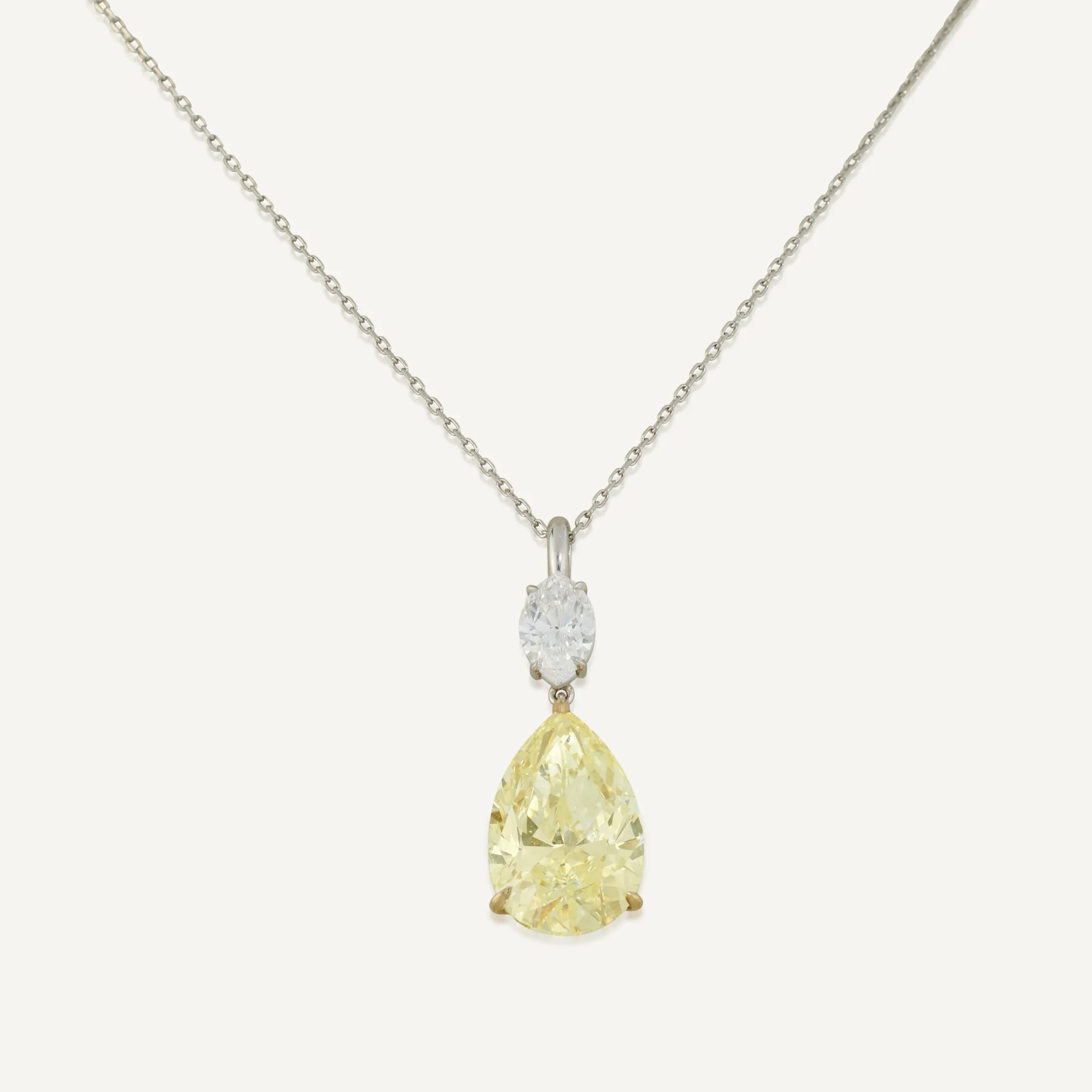 Fancy Yellow pear modified brilliant diamond of 5.12 carats, marquise-cut diamond, fine link chain necklace