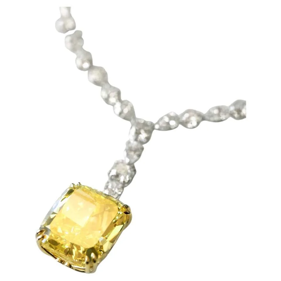 Fancy yellow cushion cut diamond of 10.27 carats in closeup, GIA certified flawless