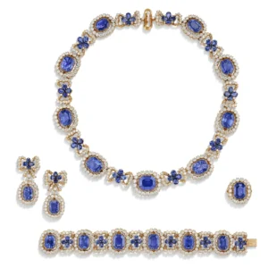 IMPRESSIVE SUITE OF SAPPHIRE AND DIAMOND 'NŒUD' JEWELLERY Comprising a necklace, a bracelet, a pair of earrings and a ri