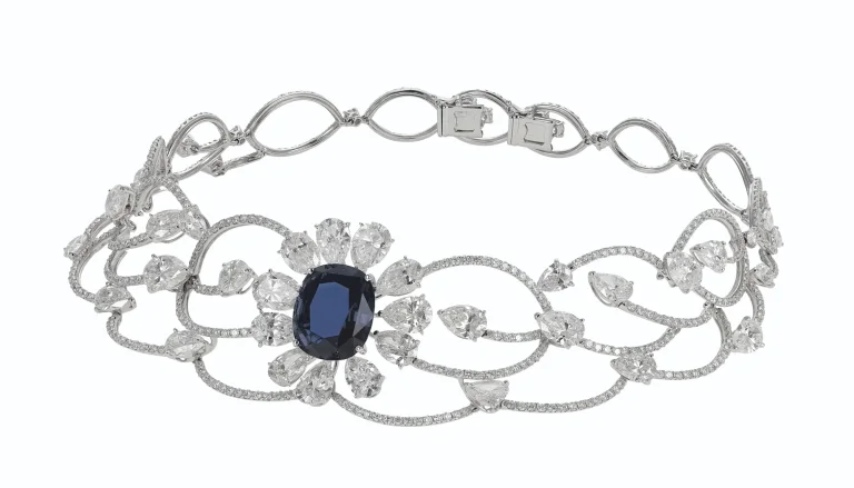 SAPPHIRE AND DIAMOND NECKLACE Cushion modified mixed-cut sapphire of 23.73 carats, circular and pear-shaped